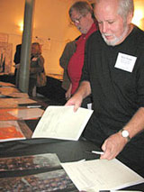 Rick Jones examines a silent auction bid sheet